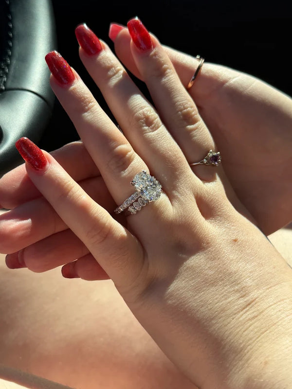 Eluri customer wearing an oval lab grown diamond engagement ring and diamond wedding band in white gold